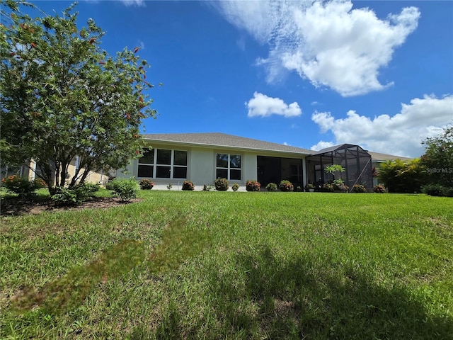 view of front of house featuring a front yard and glass enclosure