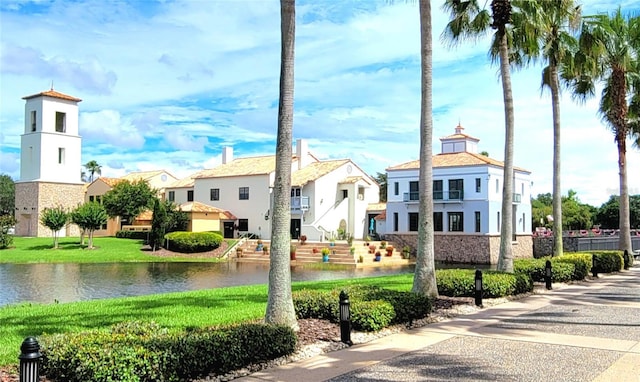 exterior space with a water view and a yard