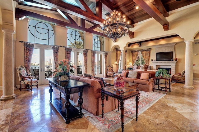 living room featuring high vaulted ceiling, beam ceiling, a chandelier, and ornate columns