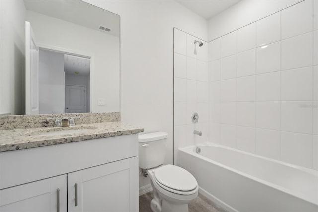 full bathroom featuring toilet, vanity, and tiled shower / bath