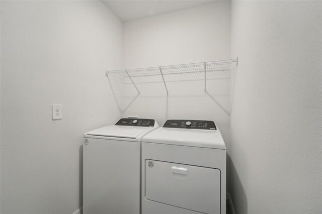 clothes washing area with washer and dryer