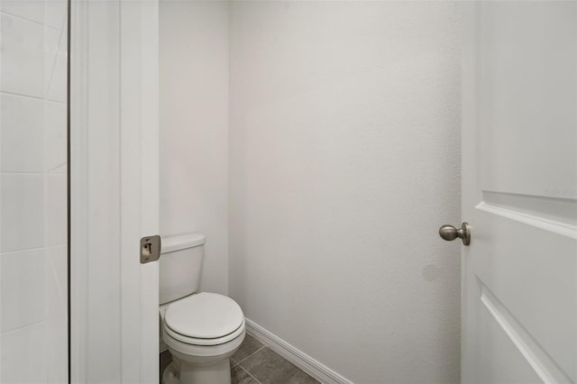 bathroom with tile patterned floors and toilet