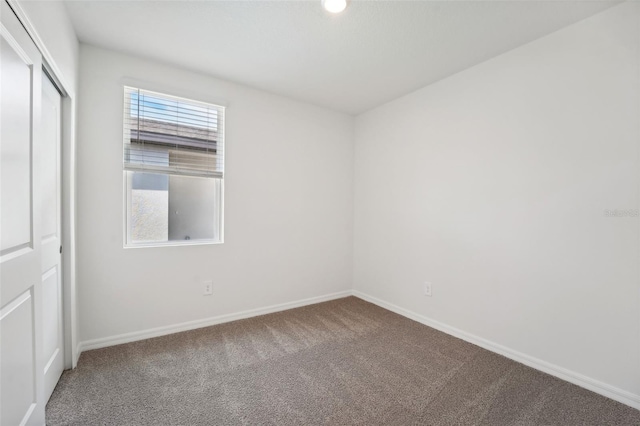 unfurnished room featuring carpet floors