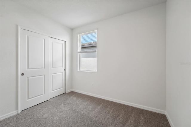 unfurnished bedroom with a closet and carpet floors