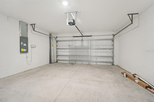 garage featuring electric panel and a garage door opener