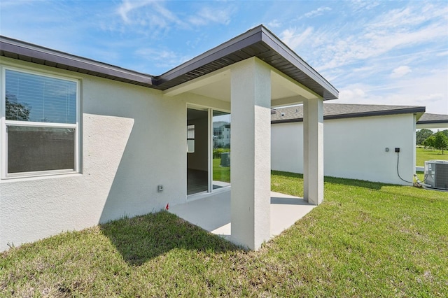 exterior space with a yard, central AC, and a patio