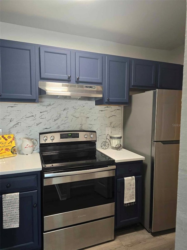 kitchen with light wood-type flooring, blue cabinetry, appliances with stainless steel finishes, and tasteful backsplash