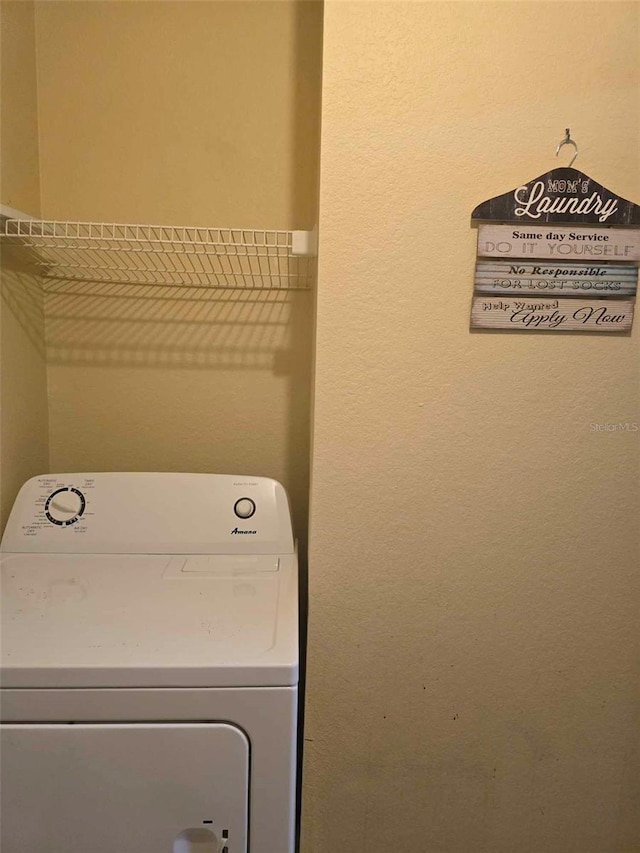 clothes washing area with washer / dryer