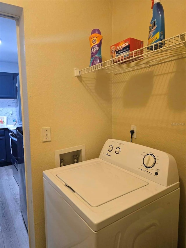 washroom featuring hardwood / wood-style floors and washer / clothes dryer