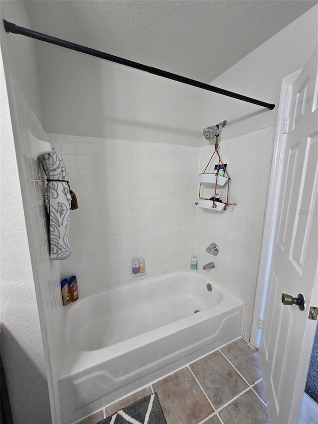 bathroom with tiled shower / bath and tile patterned floors