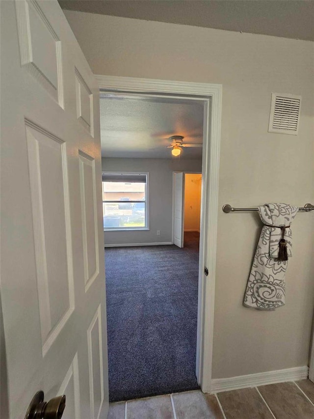 hall with tile patterned flooring