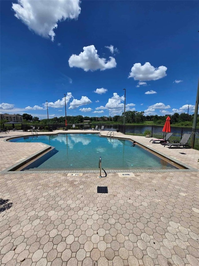 view of swimming pool with a patio