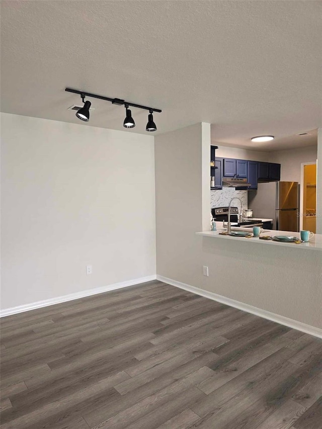 interior space featuring sink, rail lighting, dark hardwood / wood-style floors, and a textured ceiling