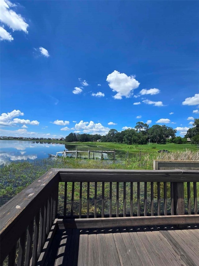 wooden deck featuring a water view