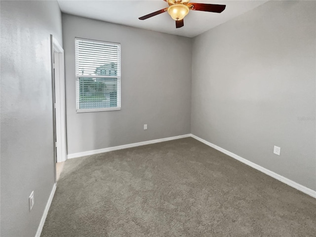 carpeted empty room featuring ceiling fan