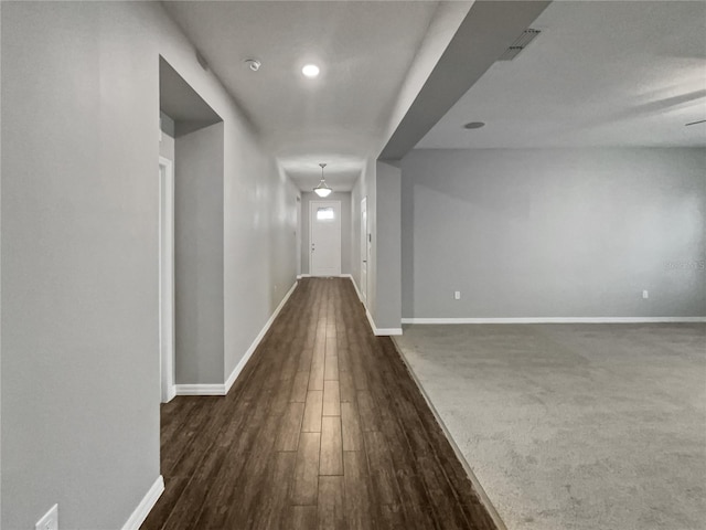 hallway with dark wood-type flooring