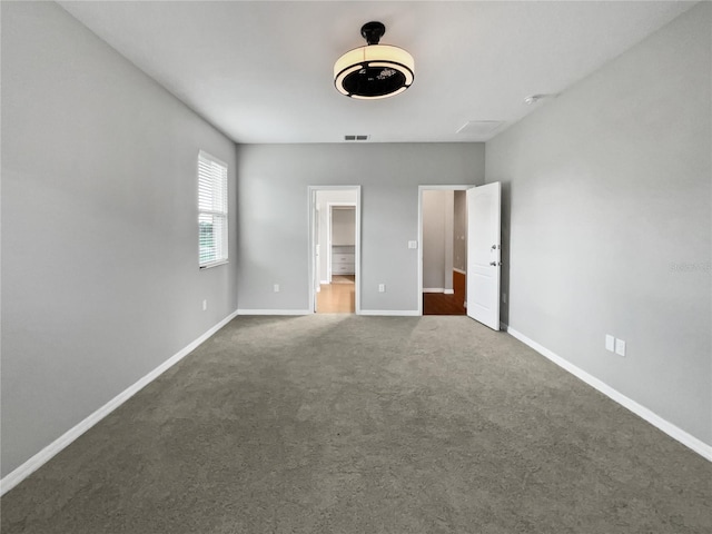 unfurnished bedroom with dark colored carpet