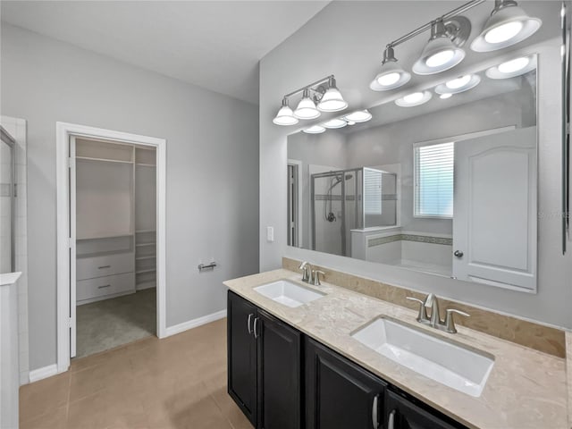 bathroom featuring a shower with door and vanity