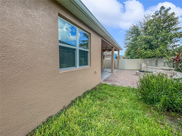 view of home's exterior with a patio and ceiling fan