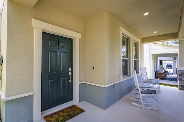 view of exterior entry with covered porch