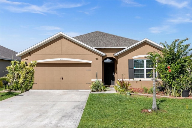 ranch-style house featuring a garage and a front yard