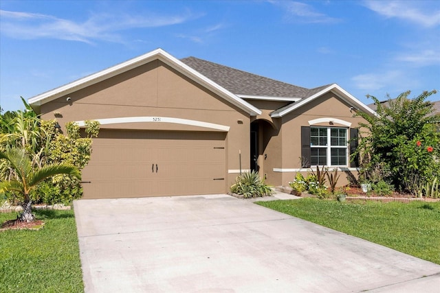 ranch-style house with a garage and a front yard