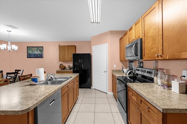 kitchen with appliances with stainless steel finishes, a center island with sink, sink, light tile patterned floors, and a notable chandelier