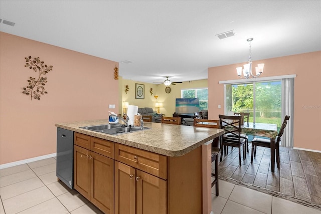 kitchen featuring sink, pendant lighting, light tile patterned floors, a kitchen island with sink, and ceiling fan with notable chandelier