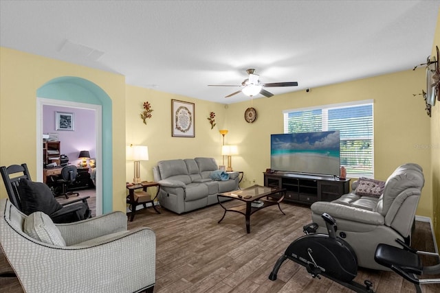 living room with ceiling fan and hardwood / wood-style floors