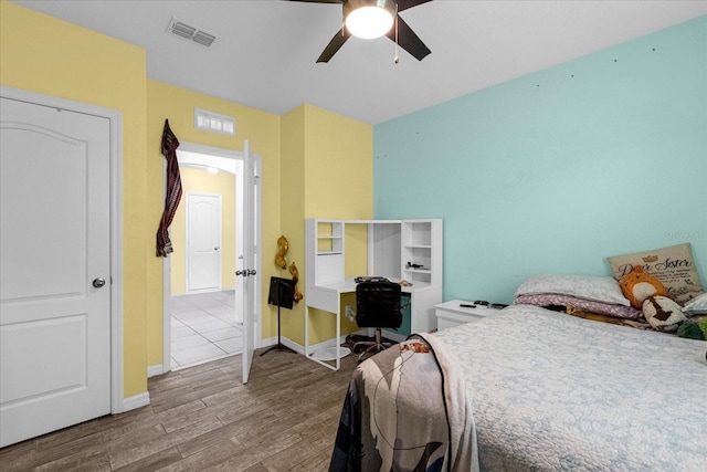 bedroom with wood-type flooring and ceiling fan