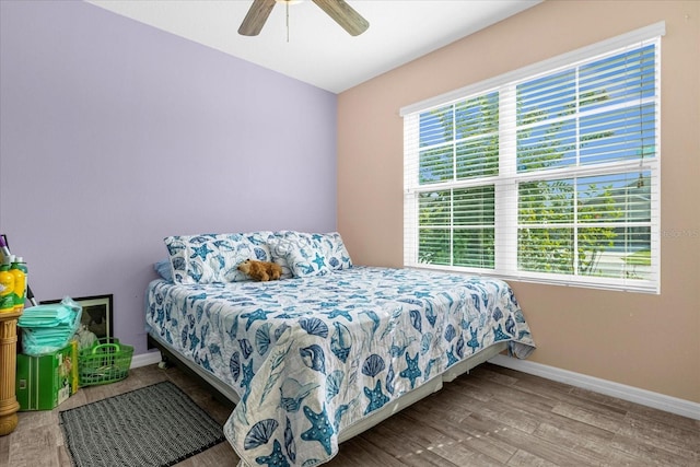 bedroom with ceiling fan and hardwood / wood-style floors