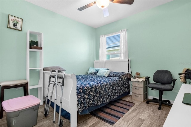 bedroom with ceiling fan and wood-type flooring