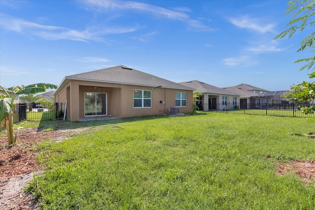 rear view of property with a yard