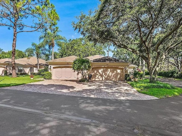 5462 Chanteclaire Unit 65, Sarasota, FL 34235 - view of front of property with decorative driveway and an attached garage