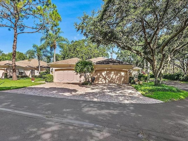 view of front of property with decorative driveway and an attached garage