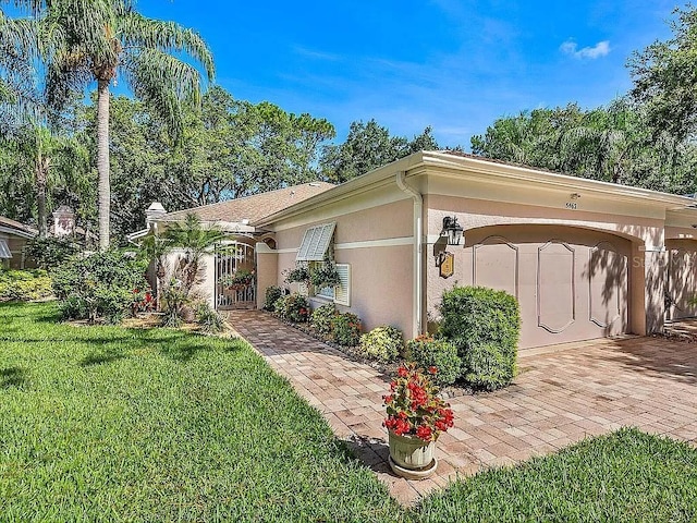 view of side of home featuring a yard and stucco siding