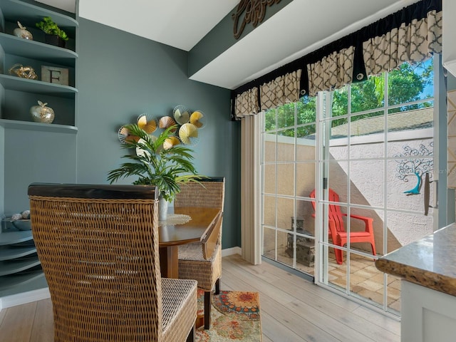 dining room with light wood-style flooring and baseboards