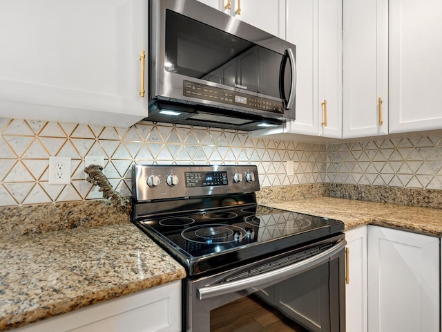 kitchen featuring white cabinetry, stainless steel appliances, and backsplash