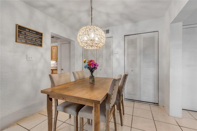 tiled dining space with a notable chandelier