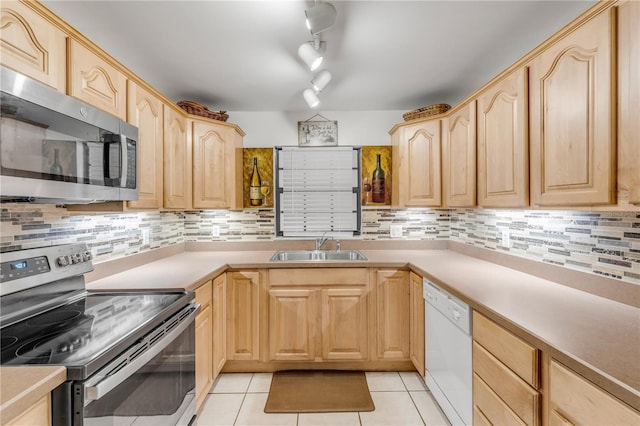 kitchen featuring light brown cabinetry, light tile patterned flooring, and stainless steel appliances