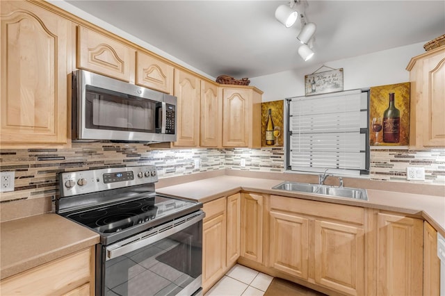 kitchen featuring sink, light brown cabinets, appliances with stainless steel finishes, and light tile patterned flooring