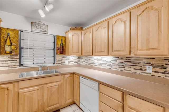 kitchen featuring light brown cabinetry, sink, decorative backsplash, white dishwasher, and light tile patterned floors