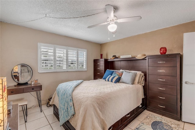 bedroom with ceiling fan, a textured ceiling, and light tile patterned floors