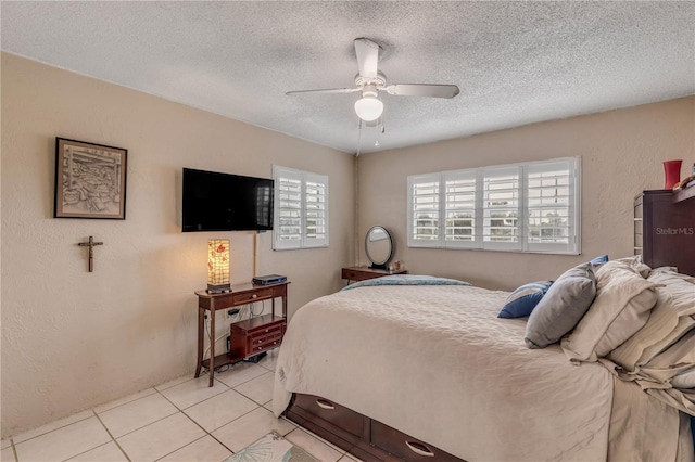 tiled bedroom featuring a textured ceiling and ceiling fan