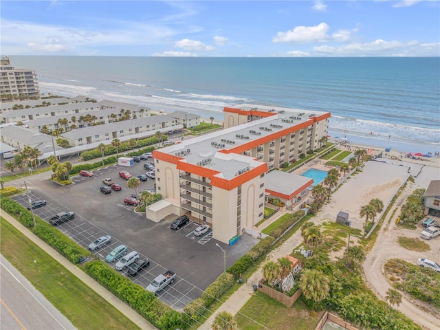 birds eye view of property featuring a water view and a beach view