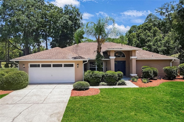 view of front of property featuring a garage and a front lawn