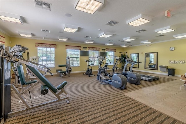 gym with crown molding and light tile patterned floors