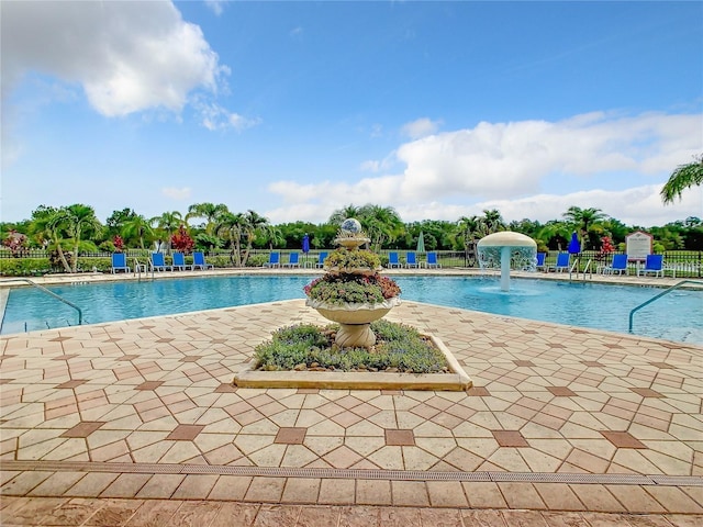 view of swimming pool featuring a patio and pool water feature