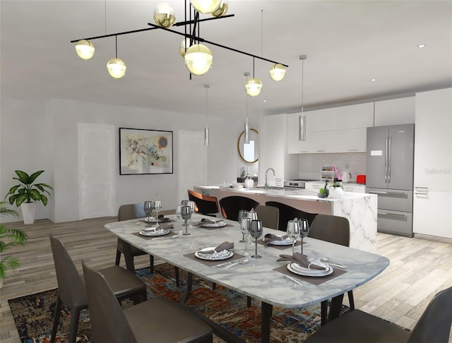 dining space with sink and light hardwood / wood-style floors