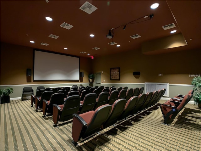 home theater room featuring light colored carpet